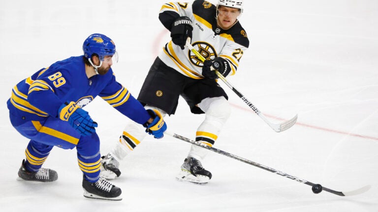 Boston Bruins defenseman Hampus Lindholm passes the puck