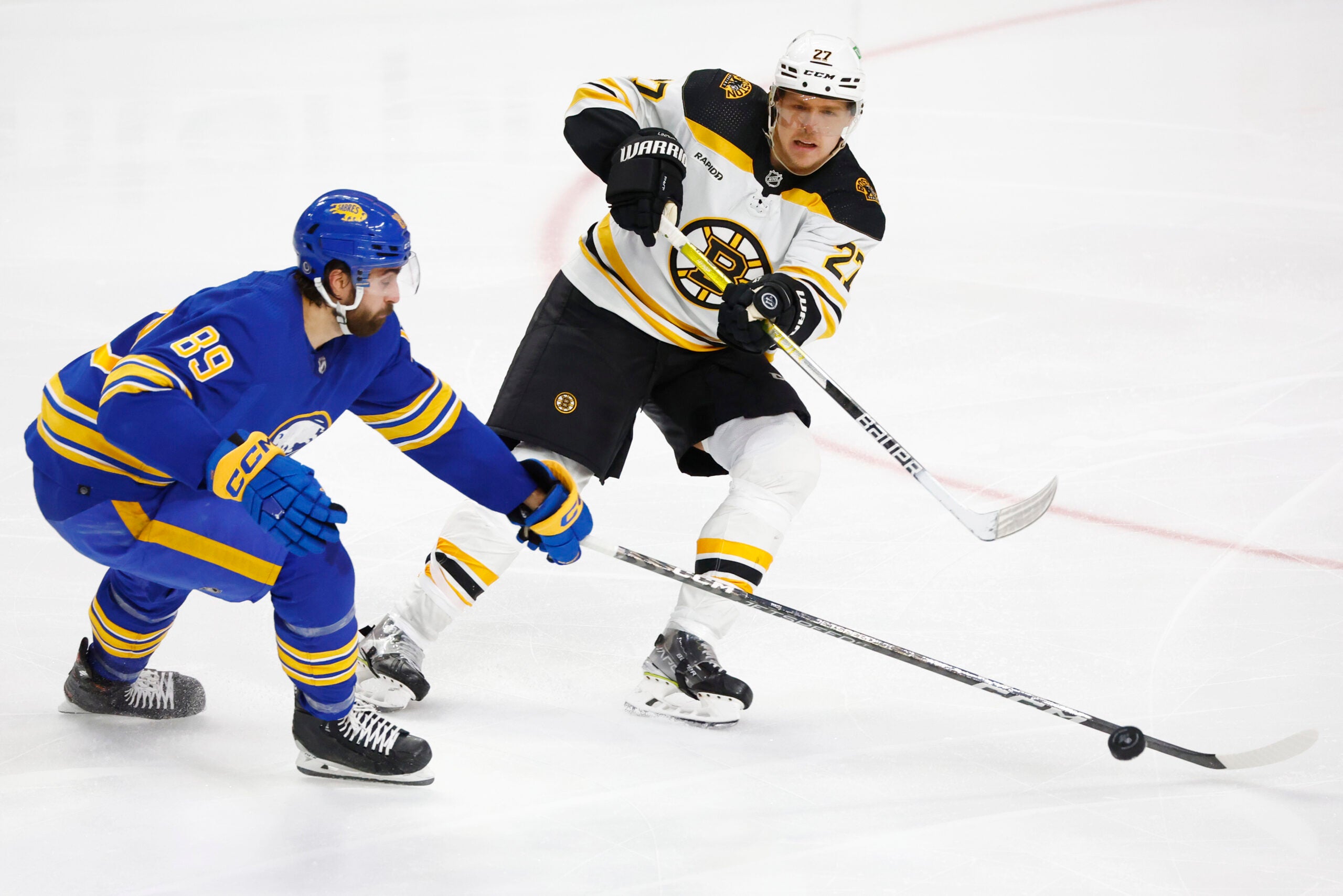 Boston Bruins defenseman Hampus Lindholm passes the puck