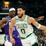 The Celtics Jayson Tatum drives to the basket.