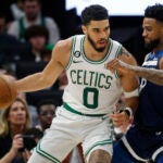 Celtics forward Jayson Tatum works against Timberwolves guard Nickel Alexander-Walker