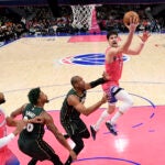 Wizards forward Deni Avdija goes to the basket past Celtics guard Marcus Smart