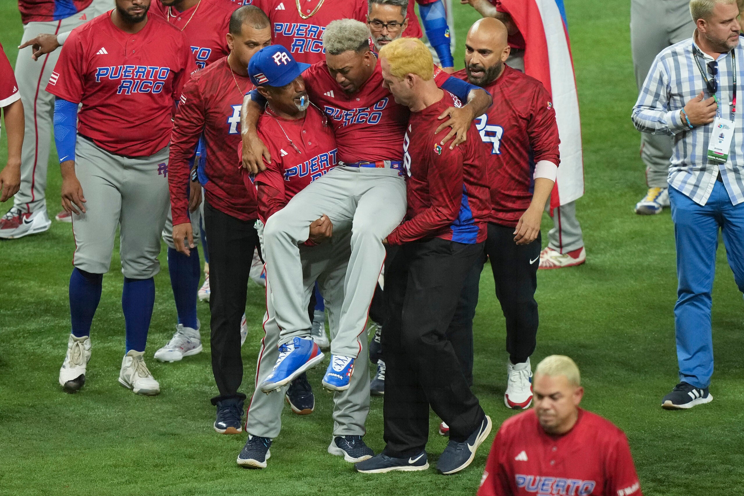 Edwin Diaz is carried off the field after suffering an injury following Puerto Rico's win in the World Baseball Classic.