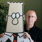 Cartoonist Scott Adams with a cardboard cutout of his character Dilbert