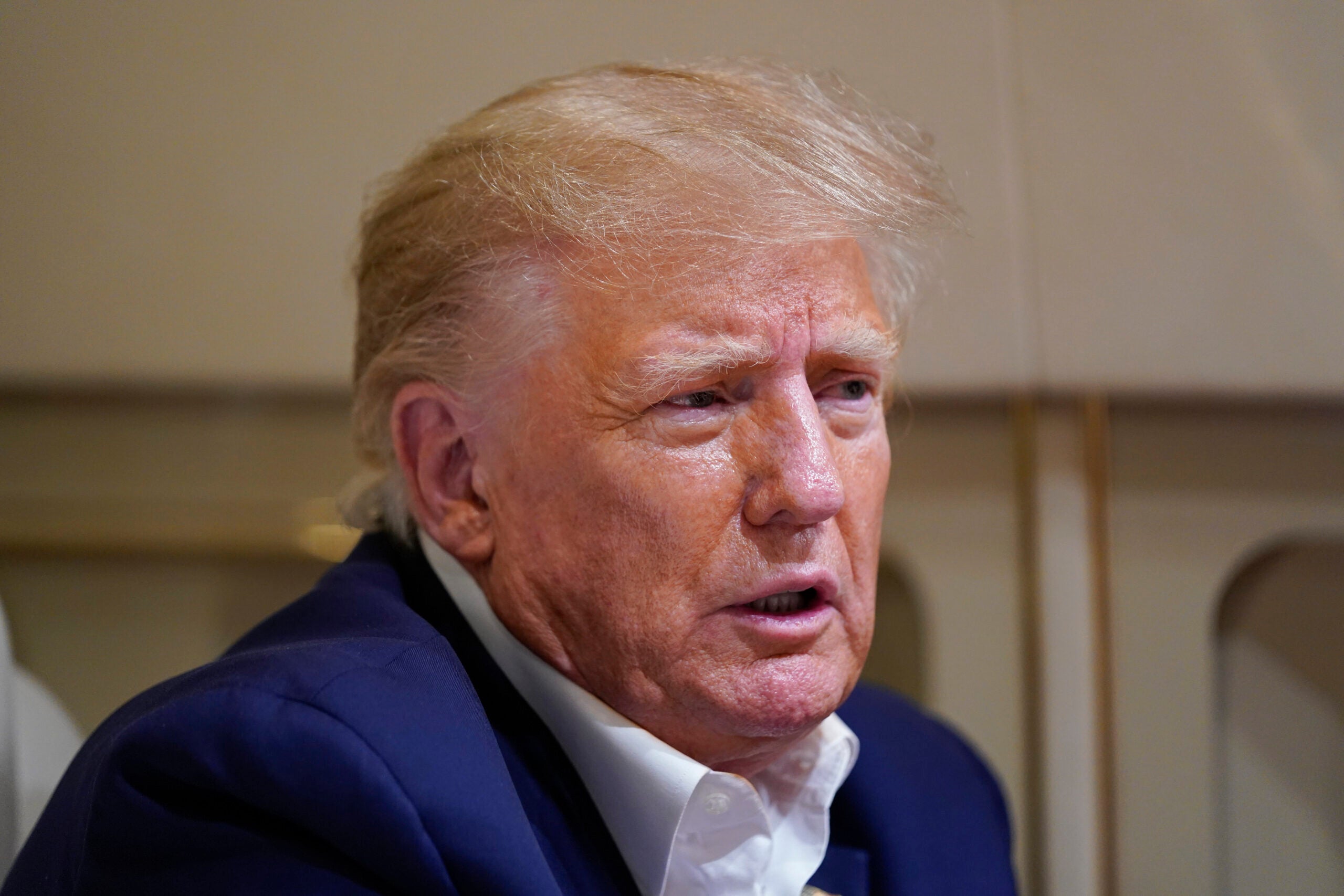Former President Donald Trump speaks with reporters.