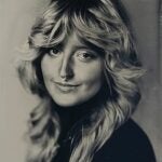 A woman is shown in a black-and-white tintype with long, feathery hair, a small smile, and nose piercings.