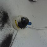 alt = an MBTA security camera vandalized with black spray paint