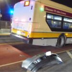 alt = A bumper that had fallen off a car, after it slammed into an MBTA bus, was abandoned on the ground in next to the rear of the bus.