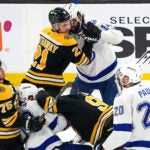 Boston Bruins right wing Garnet Hathaway (21), Tampa Bay Lightning left wing Pat Maroon (14), Boston Bruins center Jakub Lauko (94), and Toronto Maple Leafs center Bobby McMann (74) engaged in a fight right off the initial face-off during the first period. The Boston Bruins host the Tampa Bay Lightning on March 25, 2023 at TD Garden in Boston, MA.