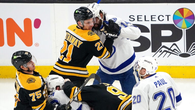Boston Bruins right wing Garnet Hathaway (21), Tampa Bay Lightning left wing Pat Maroon (14), Boston Bruins center Jakub Lauko (94), and Toronto Maple Leafs center Bobby McMann (74) engaged in a fight right off the initial face-off during the first period. The Boston Bruins host the Tampa Bay Lightning on March 25, 2023 at TD Garden in Boston, MA.