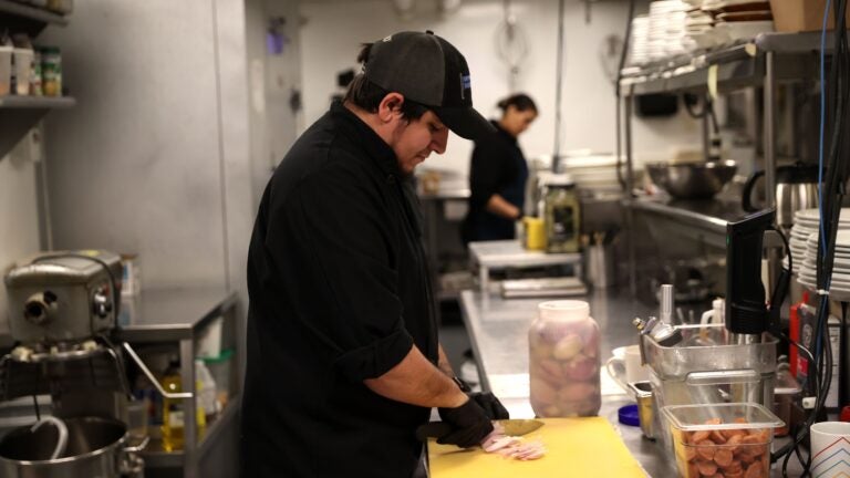 Employee Fernando Zambrano working in the kitchen at Democracy Brewing. A little over a year ago, Democracy Brewing instituted a 3.5 percent kitchen appreciation fee, which goes toward padding the wages of back-of-house workers.