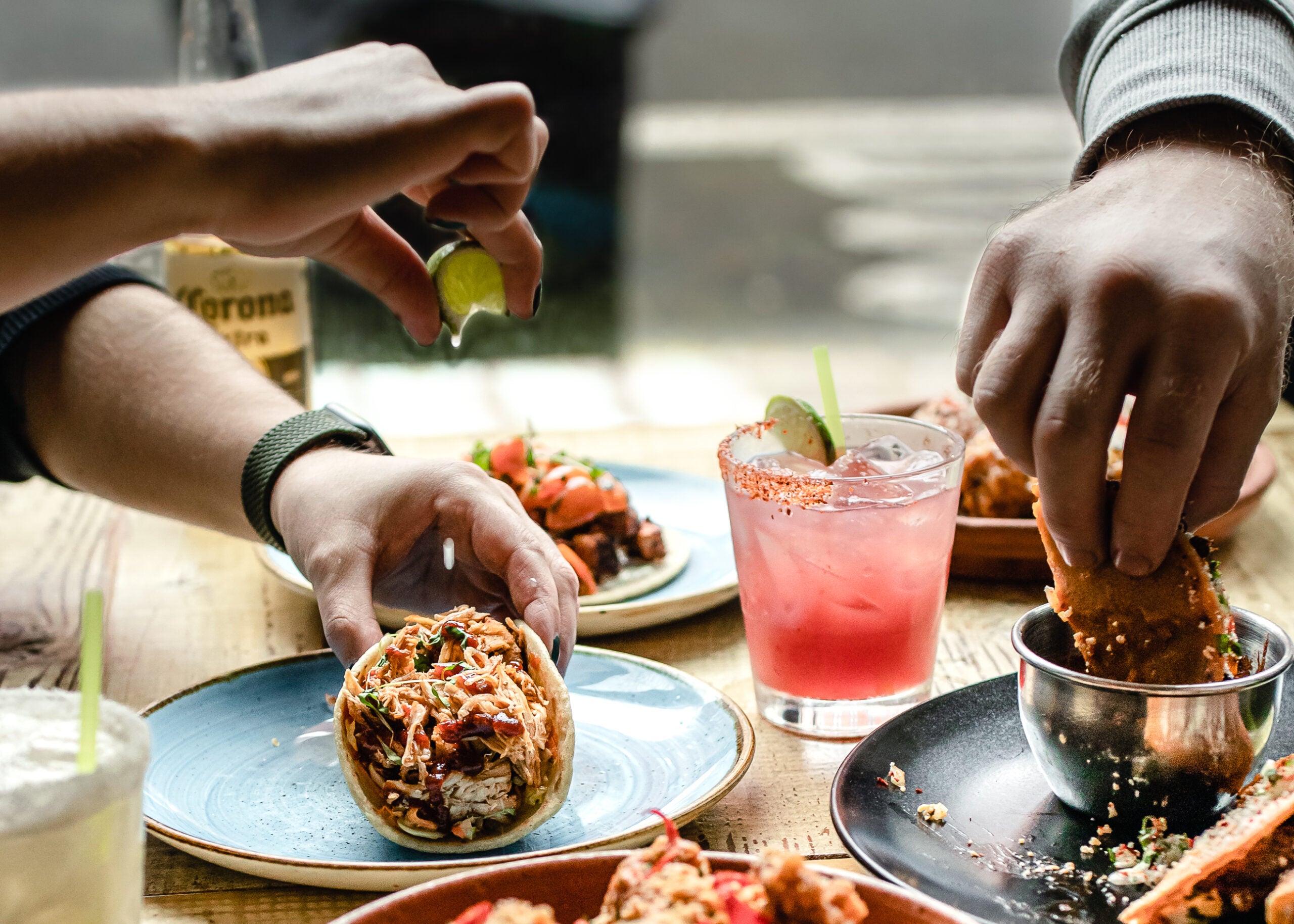 A table of tacos and margaritas at Loco