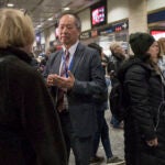 Then-Long Island Rail Road President Phillip Eng, center, talks to evening rush hour commuters at Penn Station in New York, April 17, 2018.