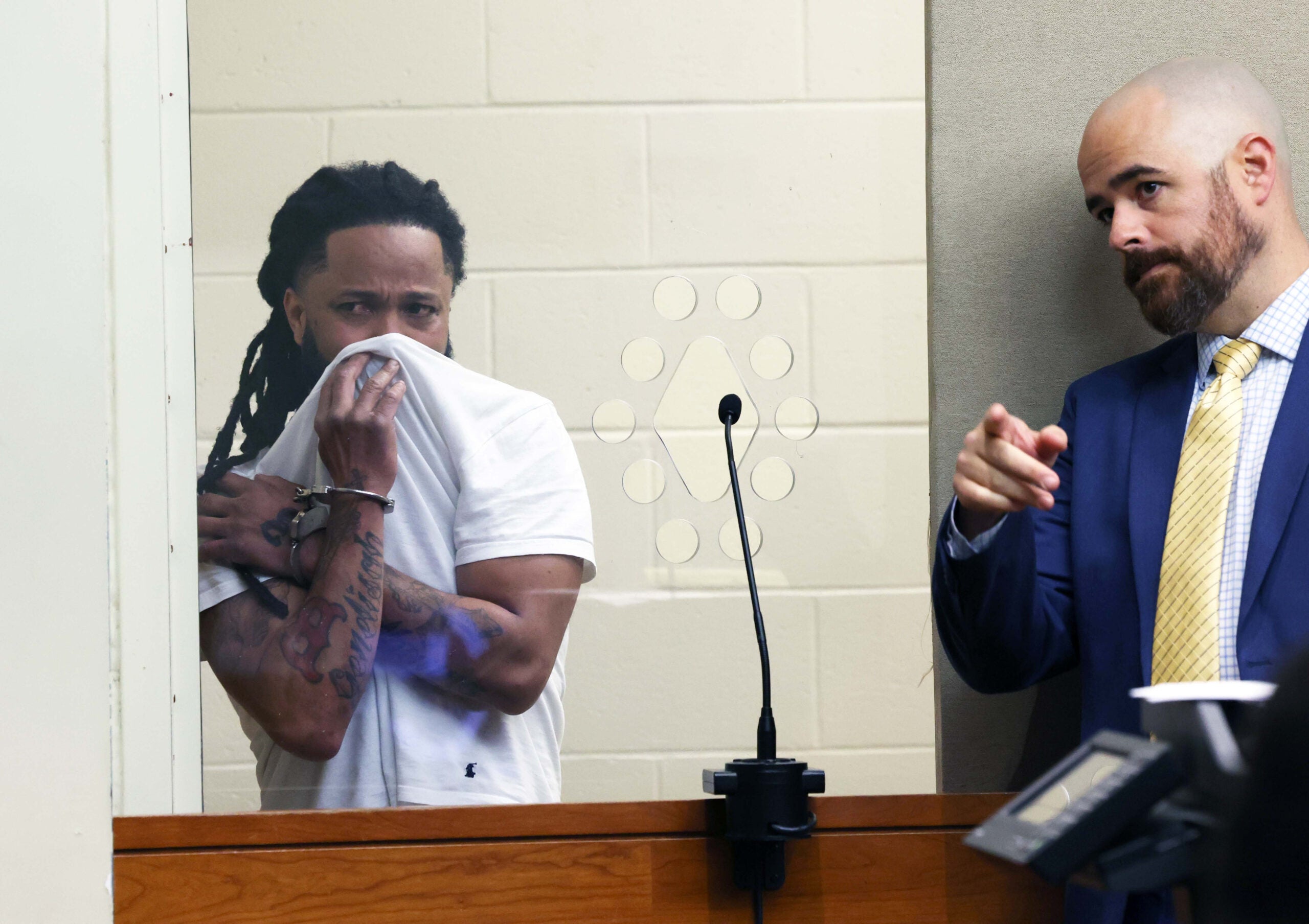 Justelino Resende, 38, left, was arraigned in Brockton District Court on Tuesday. His attorney, Daniel Pond, is pictured at right.