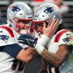 Mac Jones #10 and Jakobi Meyers #16 of the New England Patriots celebrate a 2-point conversion during the second half against the Las Vegas Raiders at Allegiant Stadium on December 18, 2022 in Las Vegas, Nevada.