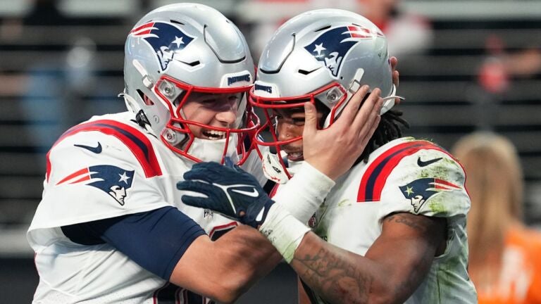 Mac Jones #10 and Jakobi Meyers #16 of the New England Patriots celebrate a 2-point conversion during the second half against the Las Vegas Raiders at Allegiant Stadium on December 18, 2022 in Las Vegas, Nevada.