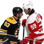 Boston Bruins left wing Brad Marchand (63) and Detroit Red Wings left wing Tyler Bertuzzi (59) exchange words during the second period. The Boston Bruins host the Detroit Red Wings at TD Garden.