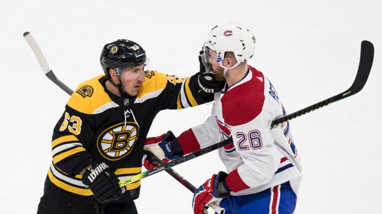 Bruins left wing Brad Marchand (63) fights with Montreal Canadiens defenseman Jeff Petry (26) during their game on Feb. 12, 2020 at TD Garden in Boston, MA.