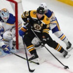 Boston Bruins left wing Brad Marchand (63) carries the puck near the Sabres net with goalie Ukko-Pekka Luukkonen in net as he is pursued by Sabres Jacob Bryson in the 1st period.