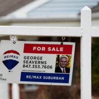 A photo of a RE/Max for-sale sign is used to illustrate a story on the average long-term U.S. mortgage rate.