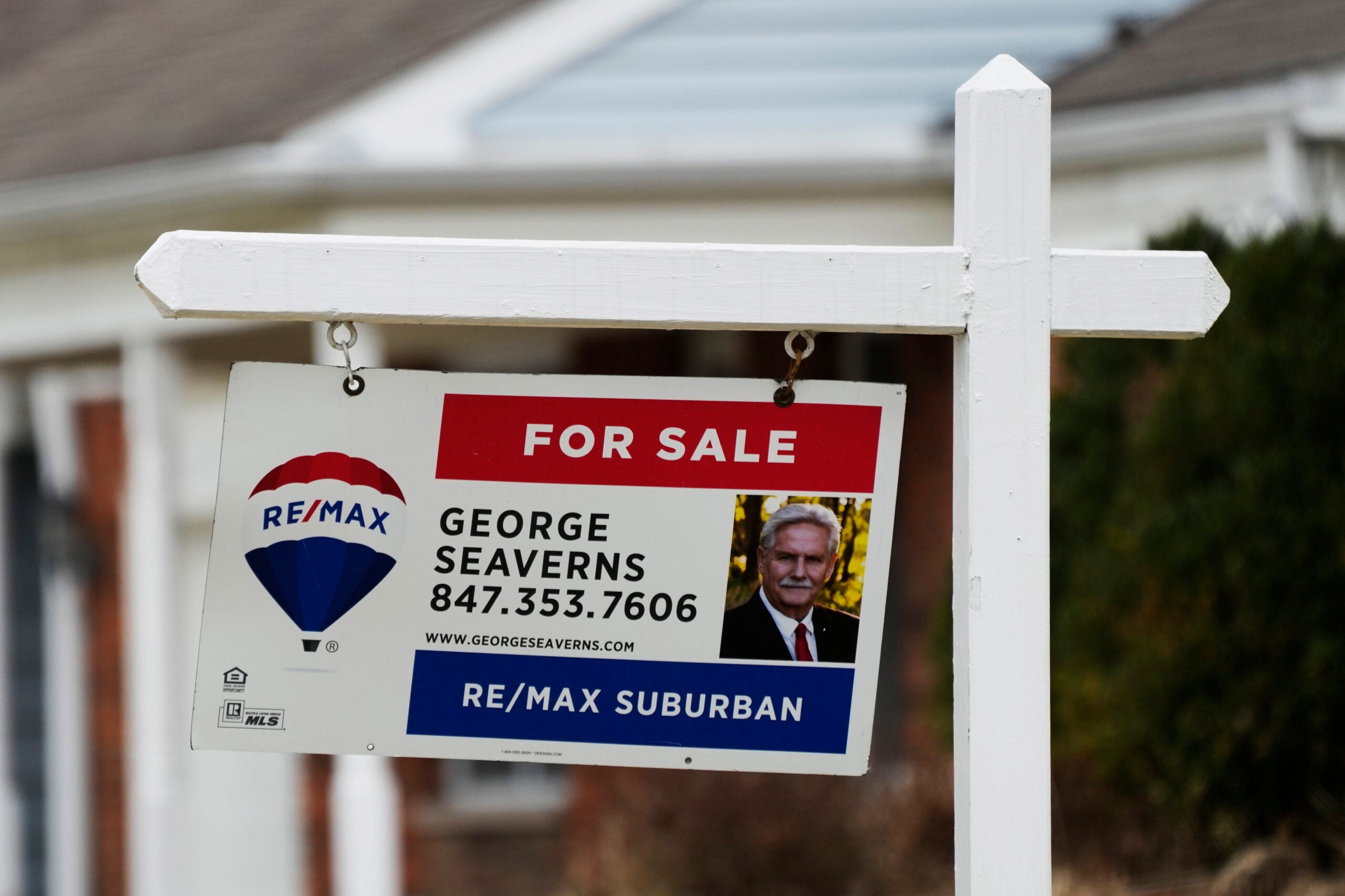 A photo of a RE/Max for-sale sign is used to illustrate a story on the average long-term U.S. mortgage rate.