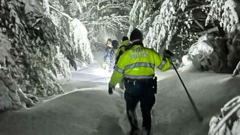 A joint search and rescue team treks in Mount Washington State Forest.