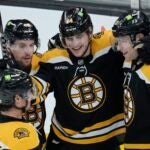 Bruins forward Jakub Lauko, center, smiles after scoring the team's seventh goal of the night against the Buffalo Sabres,