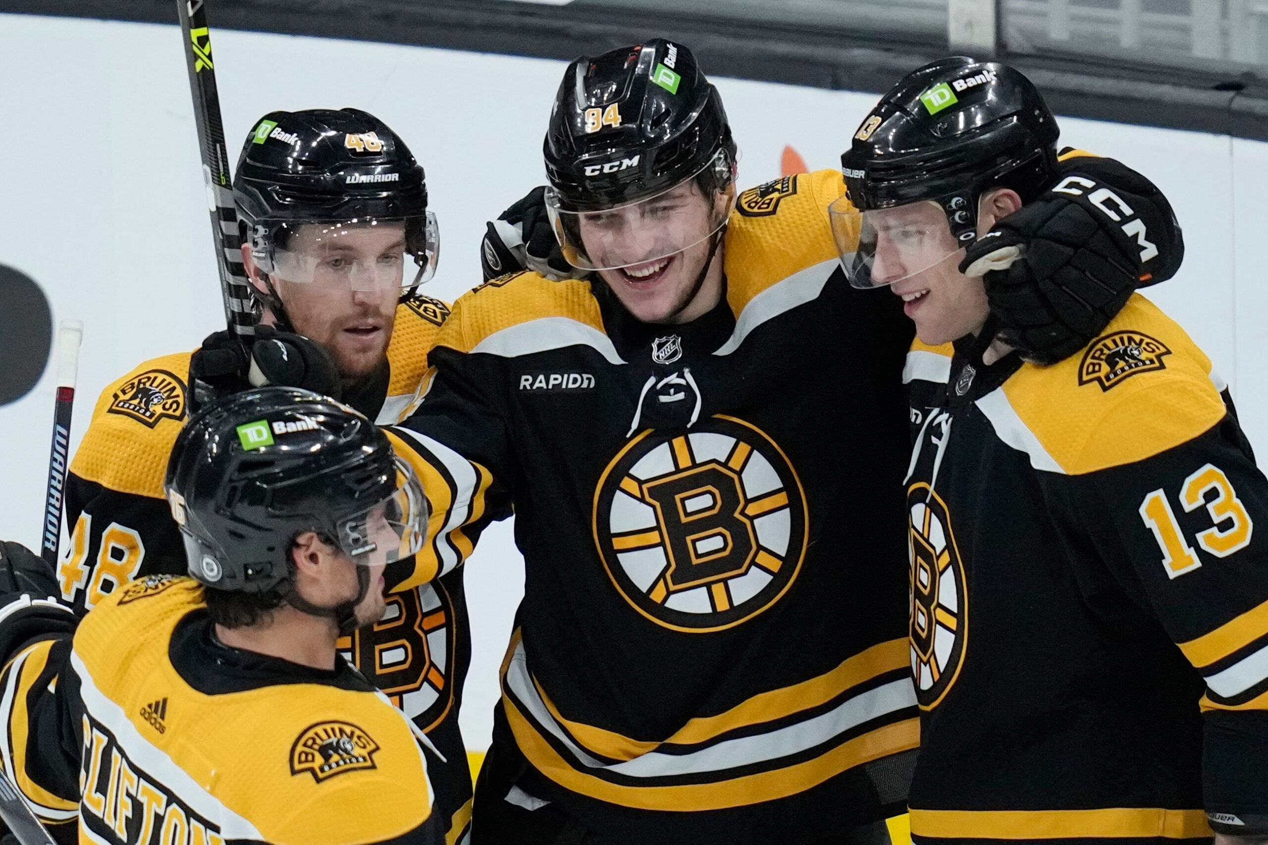 Bruins forward Jakub Lauko, center, smiles after scoring the team's seventh goal of the night against the Buffalo Sabres,