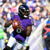Ravens quarterback Lamar Jackson looks to pass the ball