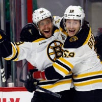 Boston Bruins' David Pastrnak (88) celebrates after his goal with teammate Tyler Bertuzzi (59) during the first period of an NHL hockey game against the Carolina Hurricanes in Raleigh, N.C., Sunday, March 26, 2023.