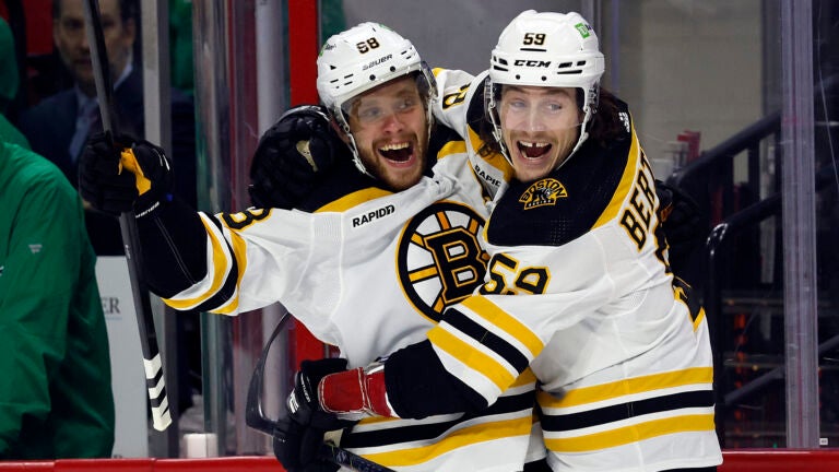 Boston Bruins' David Pastrnak (88) celebrates after his goal with teammate Tyler Bertuzzi (59) during the first period of an NHL hockey game against the Carolina Hurricanes in Raleigh, N.C., Sunday, March 26, 2023.