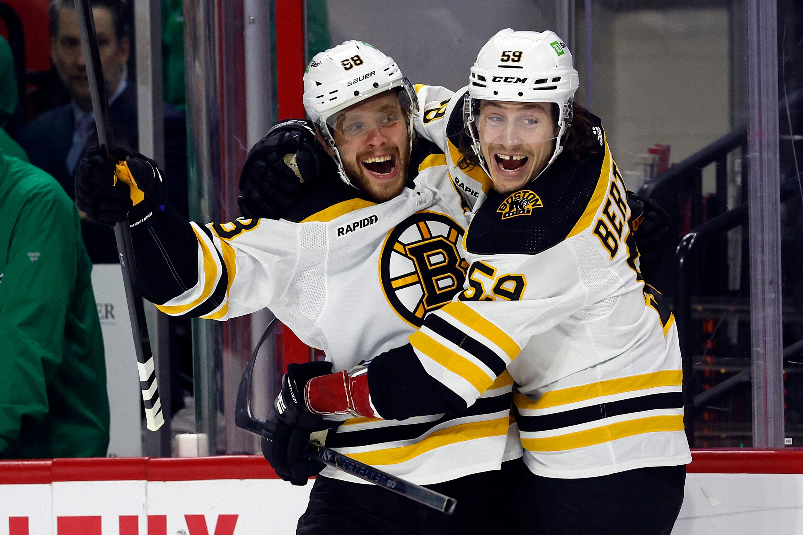 Boston Bruins' David Pastrnak (88) celebrates after his goal with teammate Tyler Bertuzzi (59) during the first period of an NHL hockey game against the Carolina Hurricanes in Raleigh, N.C., Sunday, March 26, 2023.