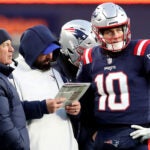 Patriots quarterback Mac Jones (right) listens to Offensive Line coach Matt Patricia while head coach Bill Belchick looks on in the fourth quarter. New England Patriots host the Cincinnati Bengals on Saturday, Dec. 24, 2022 at Gillette Stadium in Foxborough, MA.