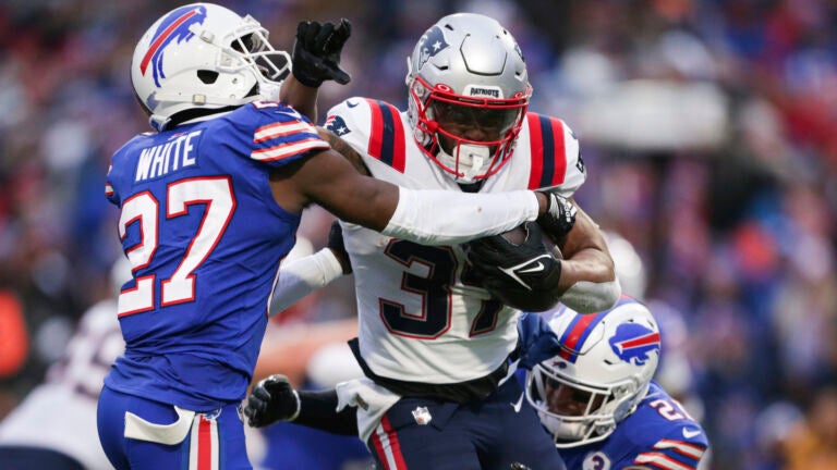 Buffalo Bills cornerback Tre'Davious White (27) and safety Jordan Poyer (21) tackle New England Patriots running back Damien Harris (37) during the second half of an NFL football game Sunday, Jan. 8, 2023, in Orchard Park, N.Y.