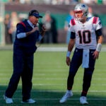 New England Patriots head coach Bill Belichick talks with quarterback Mac Jones (10) during the second quarter of an NFL football game, Sunday, Oct. 30, 2022, in New York.