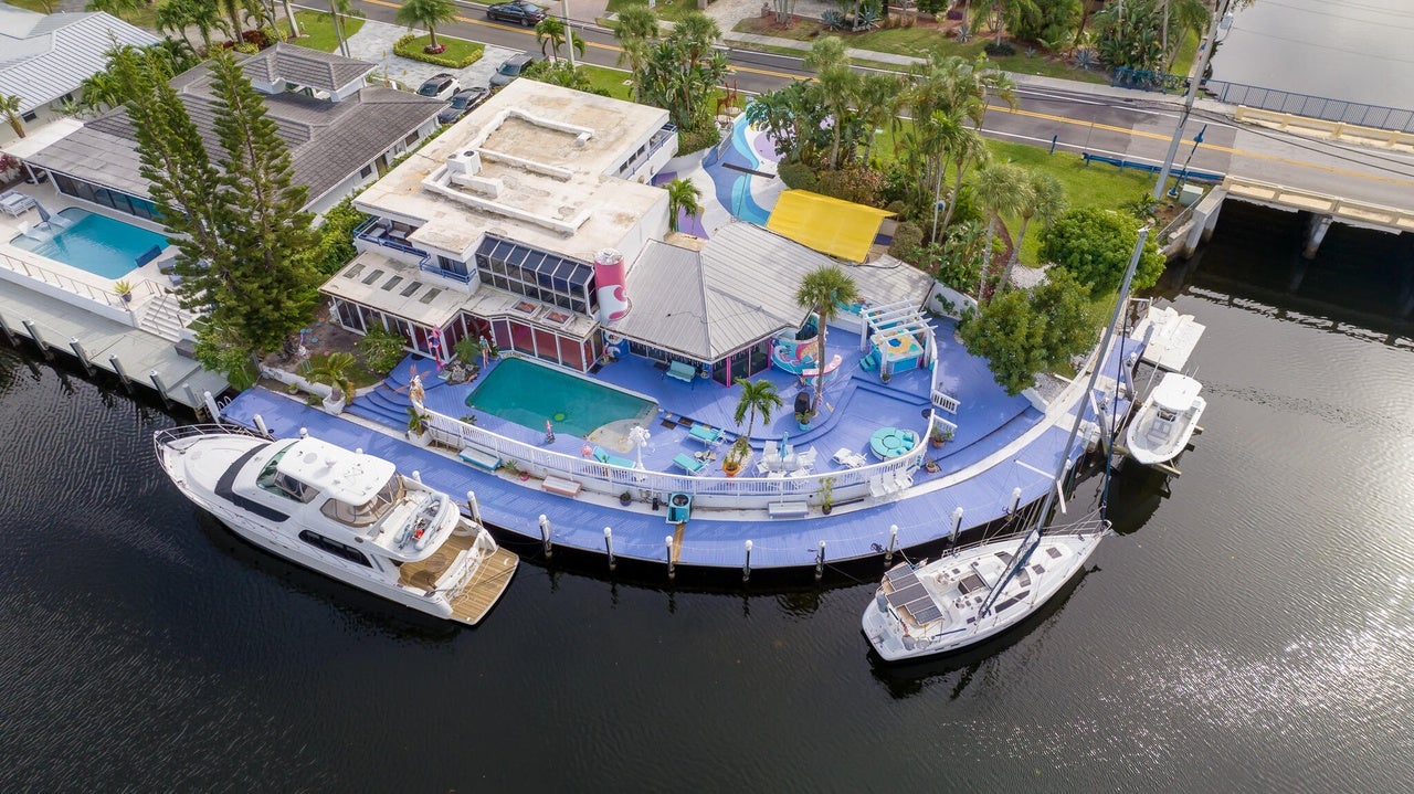 The house has a purple 200-foot dock that stands out from a bird's eye view.