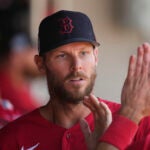Boston Red Sox starting pitcher Chris Sale is greeted in the dugout after pitching in the third inning of a spring training baseball game against the Minnesota Twins in Fort Myers, Fla., Saturday, March 11, 2023.