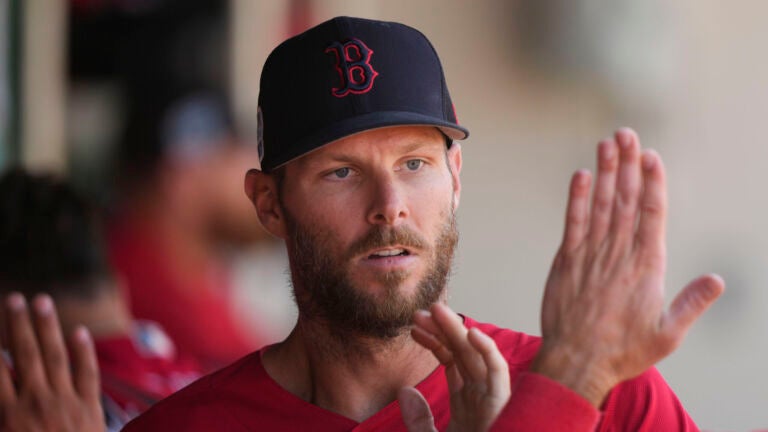 Boston Red Sox starting pitcher Chris Sale is greeted in the dugout after pitching in the third inning of a spring training baseball game against the Minnesota Twins in Fort Myers, Fla., Saturday, March 11, 2023.