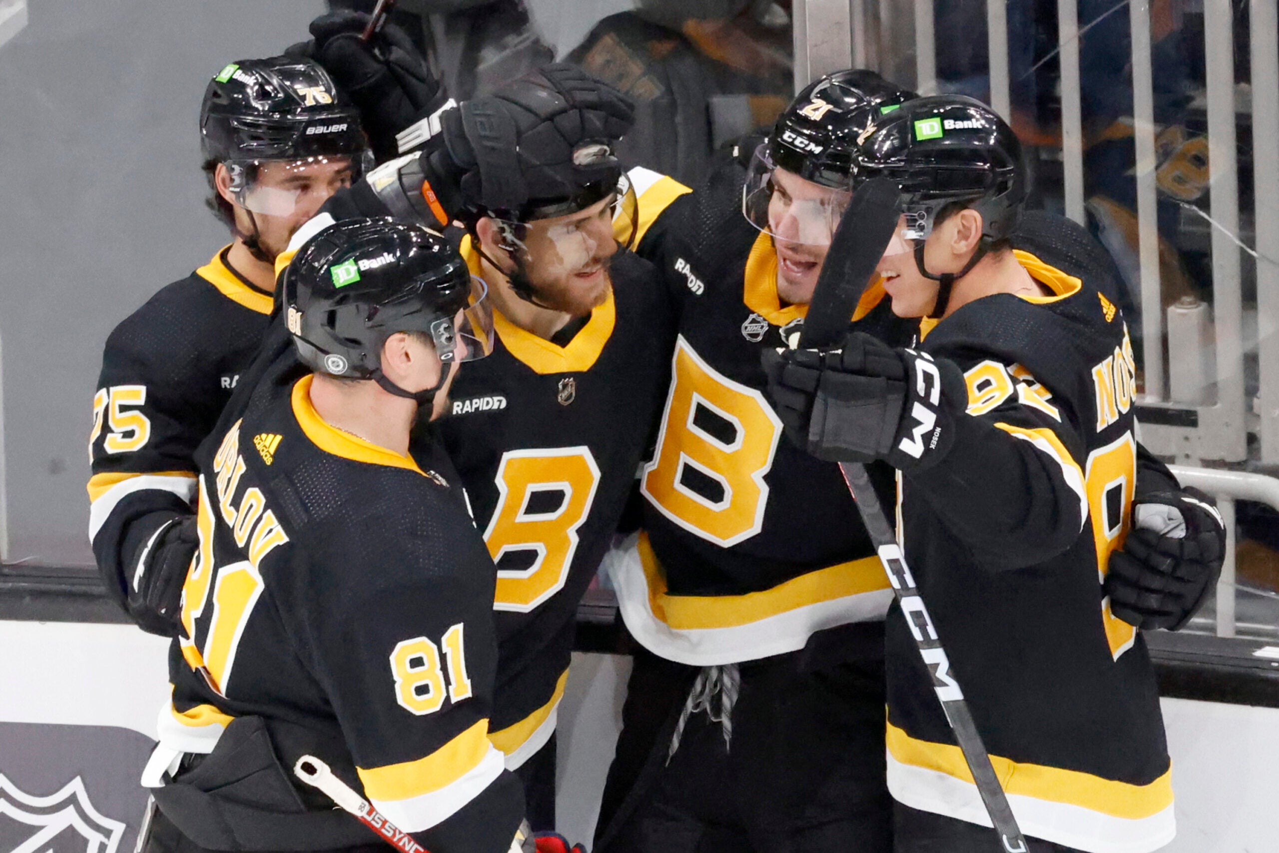 Boston Bruins players congratulate teammate Garnet Hathaway (21) after he scored the game-winning goal against the Detroit Red Wings during the third period of an NHL hockey game, Saturday, March 11, 2023, in Boston.