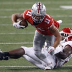 Rutgers linebacker Olakunle Fatukasi, right, tackles Ohio State receiver Jaxon Smith-Njigba during the second half of an NCAA college football game Saturday, Nov. 7, 2020, in Columbus, Ohio. Ohio State won 49-27.