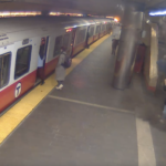 A video still shows a person standing in the MBTA's Harvard Station, surrounded by dust after a ceiling panel fell in front of them, narrowly missing them.