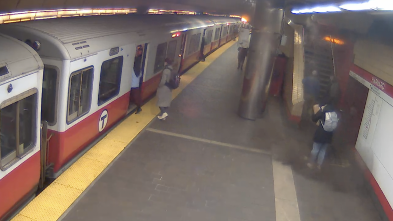 A video still shows a person standing in the MBTA's Harvard Station, surrounded by dust after a ceiling panel fell in front of them, narrowly missing them.
