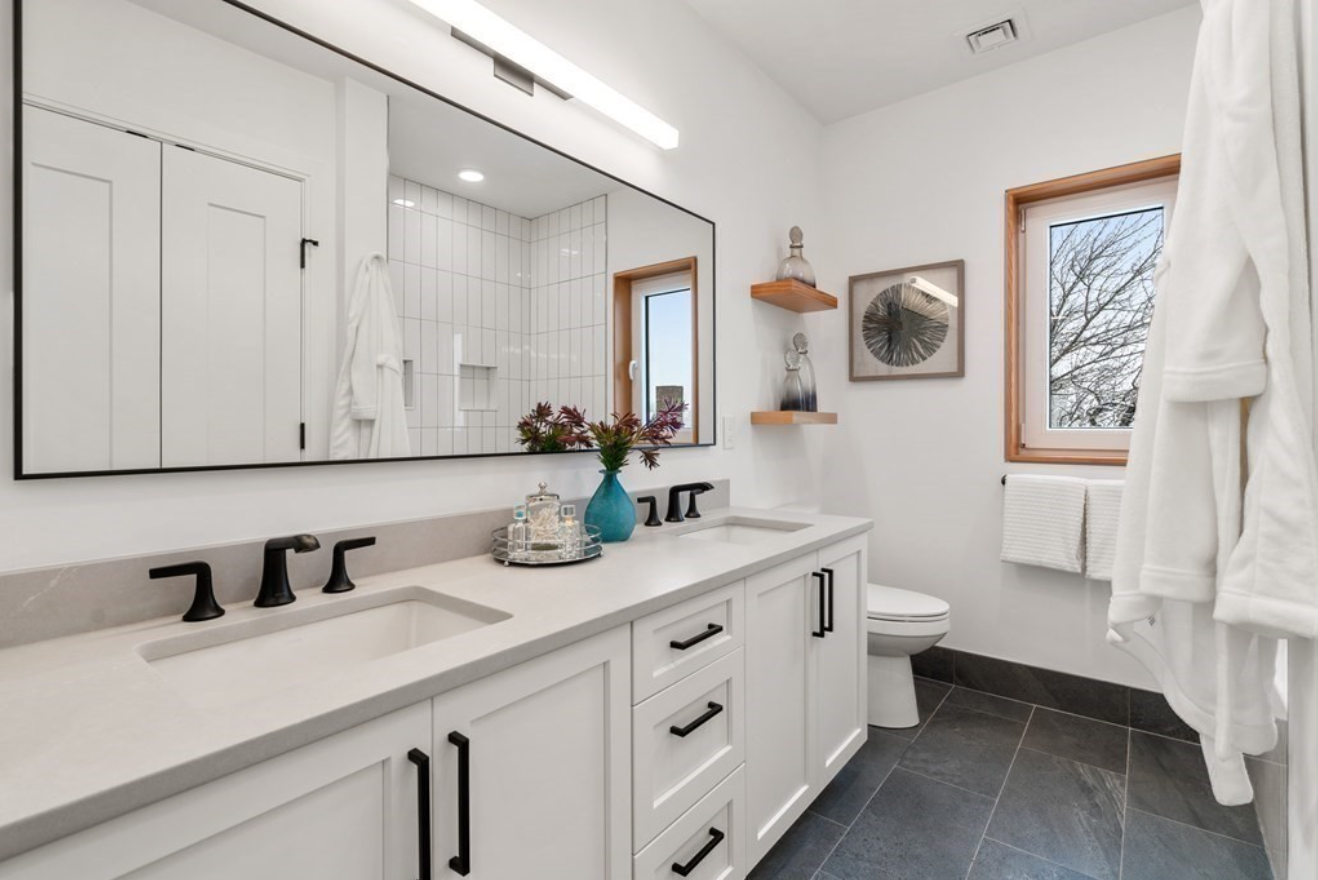 The full bathroom includes a double vanity and walk-in shower.