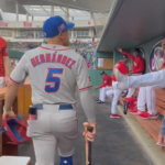 Kike Hernandez walking through the Red Sox dugout in his Puerto Rico uniform.