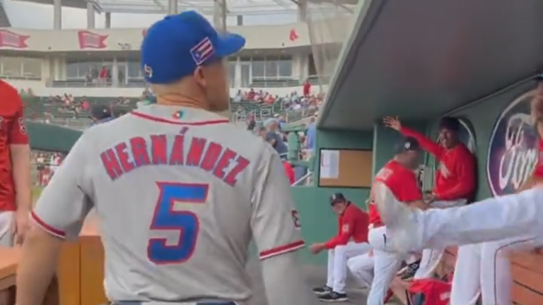 Kiké Hernández walks through the Red Sox dugout as an opponent