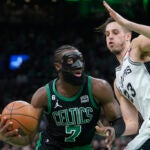 Jaylen Brown (7) drives toward the basket as San Antonio Spurs forward Zach Collins