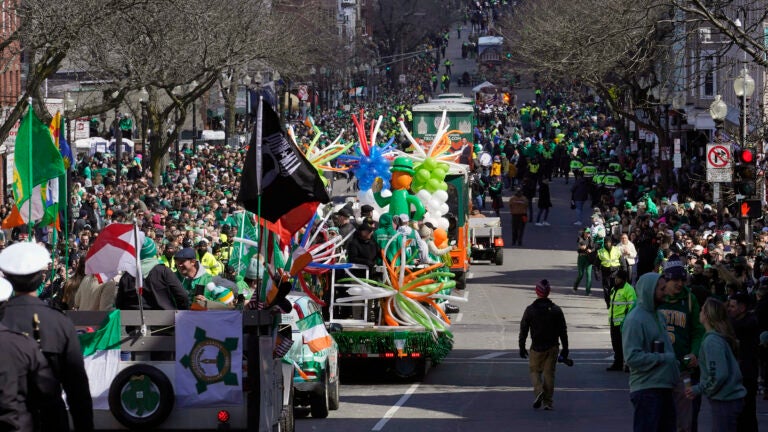 Vehicles in Boston's St. Patrick's Day parade make their way along the parade route