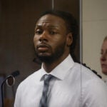 Csean Skerritt, 34, is pictured during his arraignment, wearing a white button-down shirt and tie.