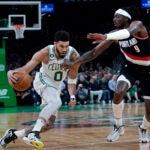 Jayson Tatum drives to the basket against Portland Trail Blazers forward Jerami Grant