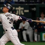 Masataka Yoshida hitting for team Japan in the World Baseball Classic.
