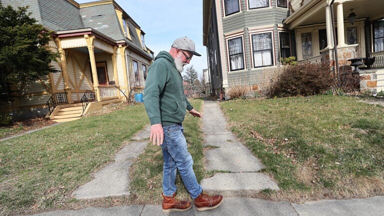 Matt Malloy showed where a new driveway will be installed for a charging station at his home in Dorchester.